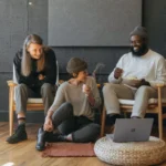 three professionals collaborating in a minimalist workspace to unlock marketing strategies using digital tools and teamwork